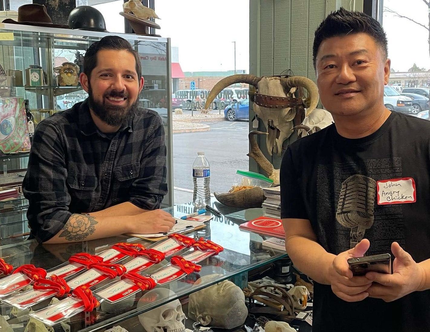 Photo from 2022 Yelp Colorado Elite at Heirlooms. Matt C and John Kim from Angry Chicken taking a photo with the Yelo CO Name Badges at Check in. 